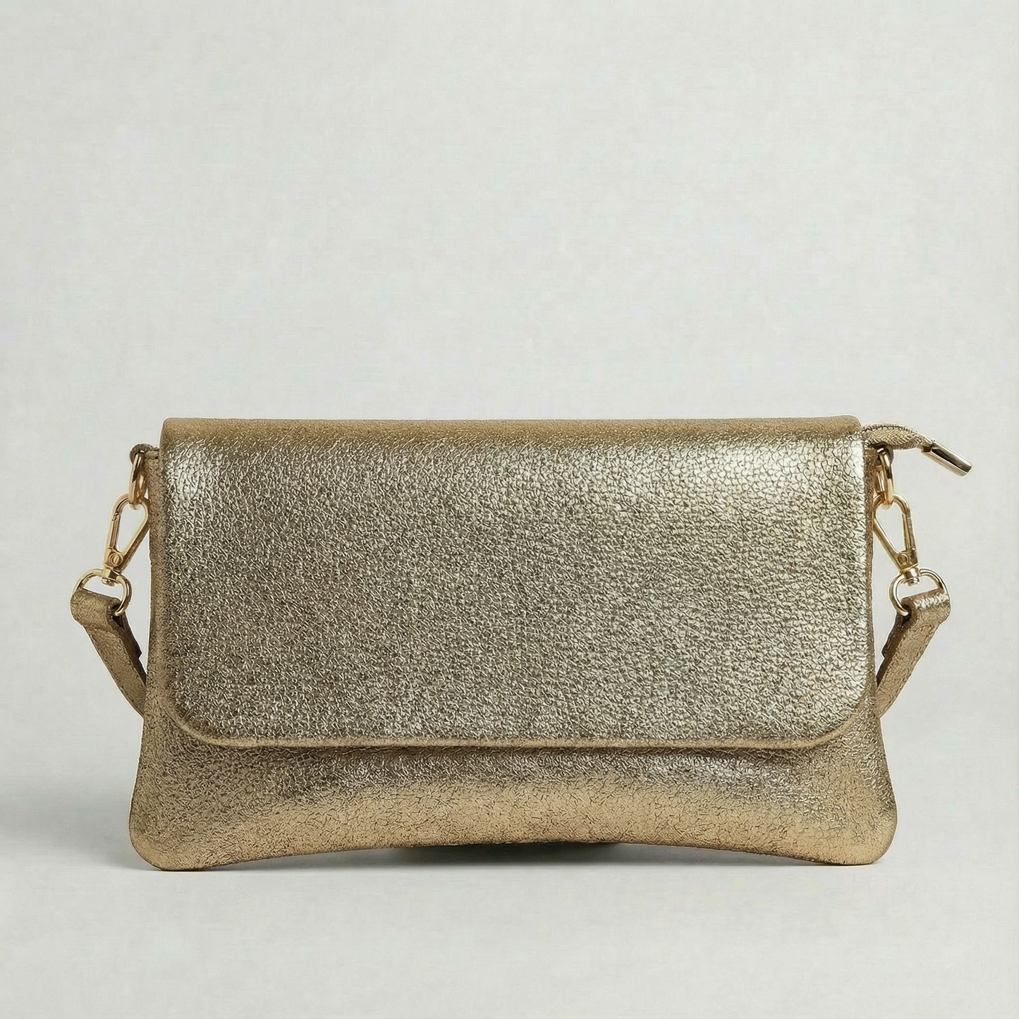 Antique Gold metallic leather crossbody bag with a matching color leather strap, displayed on a light gray background.