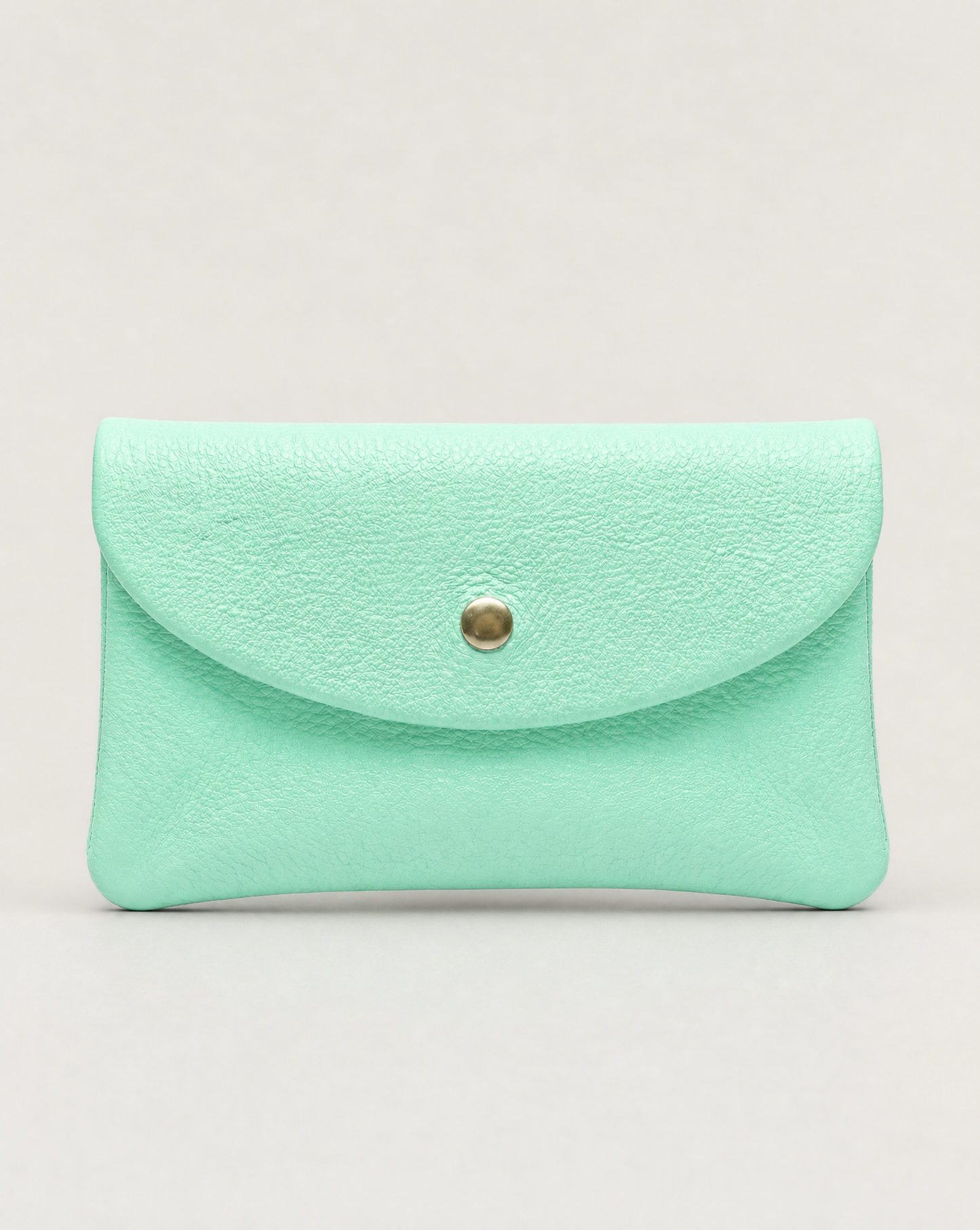 Aqua pebble leather coin wallet with snap closure, minimalist Italian design, compact and elegant everyday accessory.