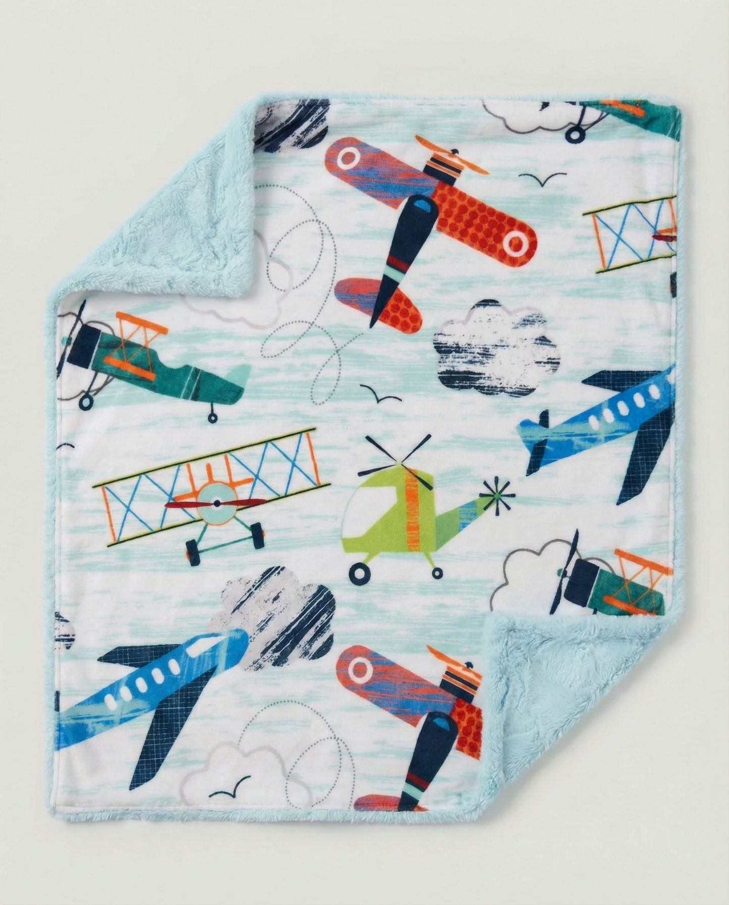 Baby blanket with airplane pattern on a light blue background