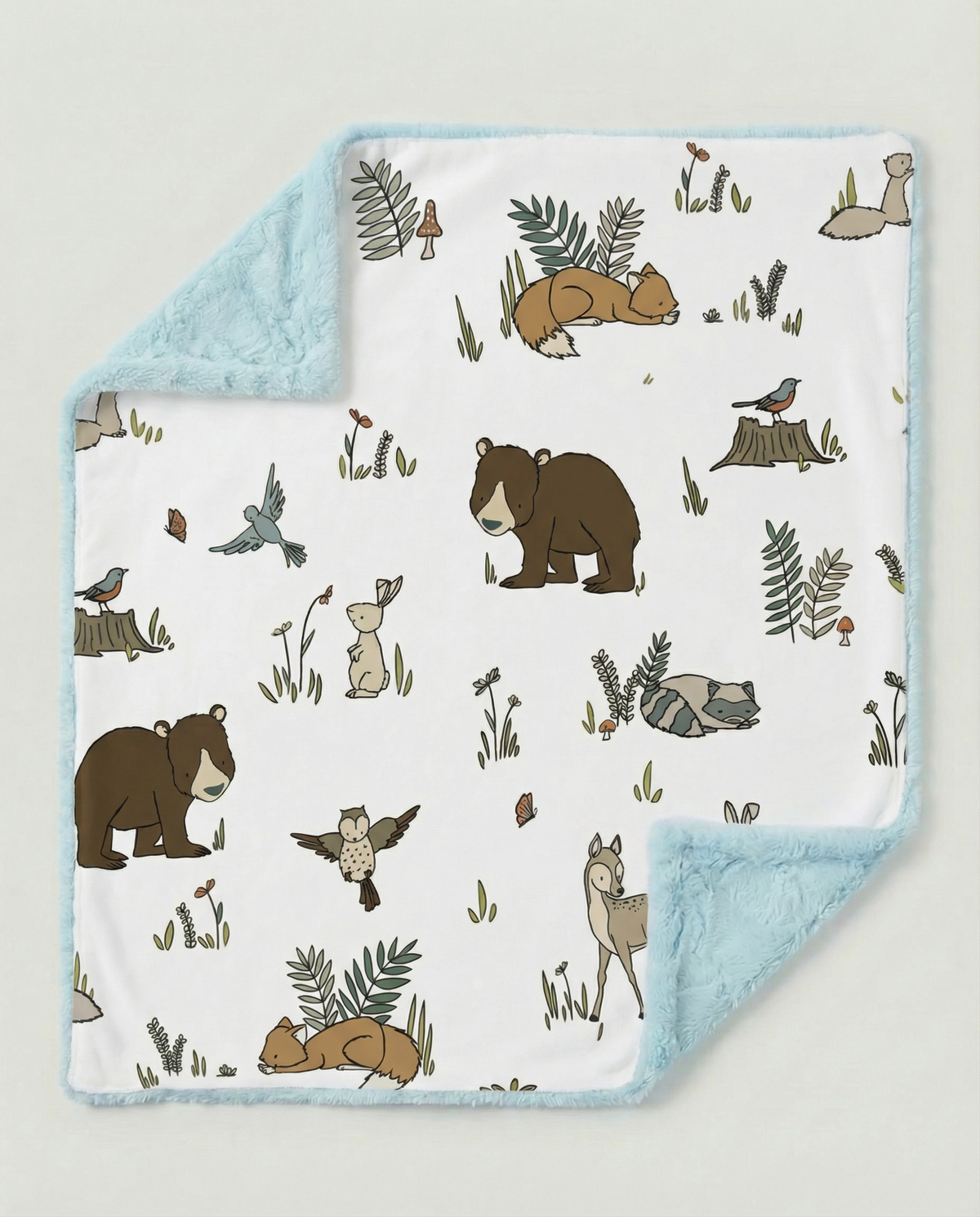 Baby blanket with forest animal pattern on a light gray background