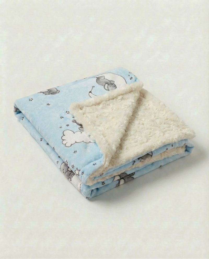 Lullaby blue baby blanket with sleeping baby elephant on the moon with clouds and stars and plush ivory rosebud backing.
