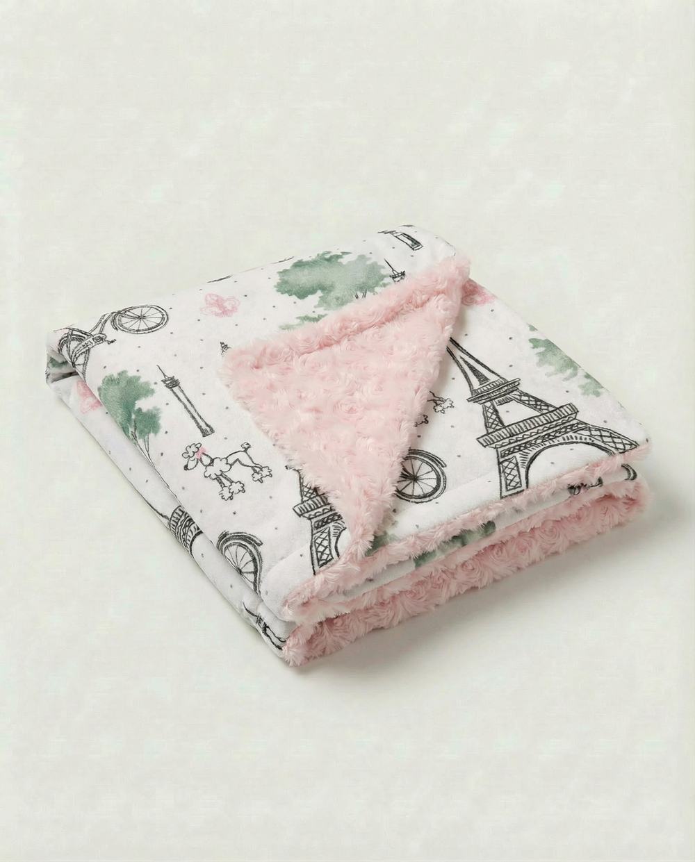 Baby blanket with Eiffel Tower Paris print and plush pink rosebud embossed backing for cozy newborn snuggles.