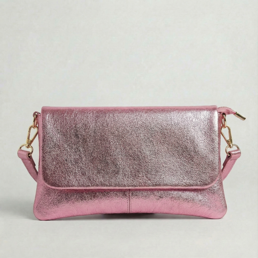 Barbie Pink metallic leather crossbody bag with a matching color leather strap, displayed on a light gray background.