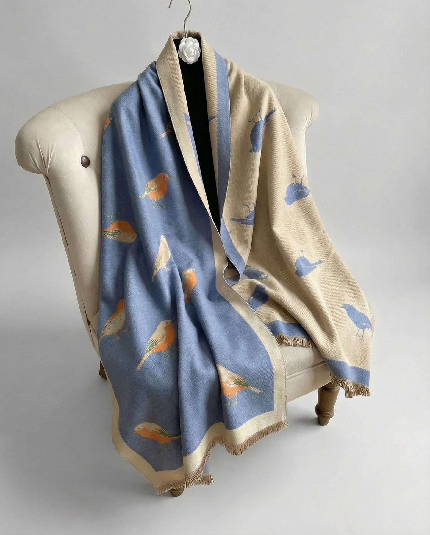 Blue wrap with bird pattern on a chair with light gray background
