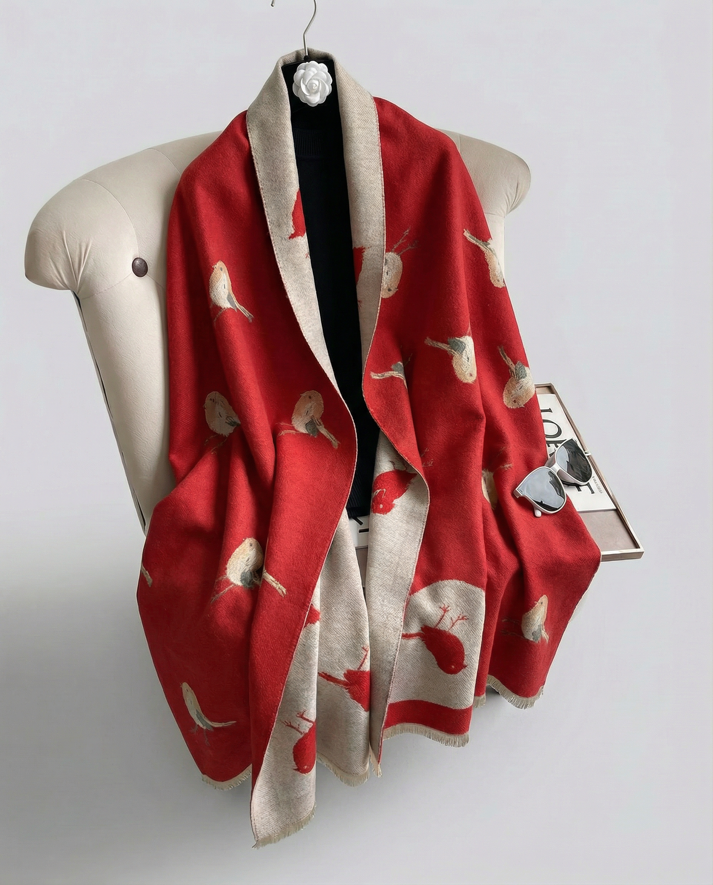 Red wrap with bird pattern draped over a mannequin on a white background