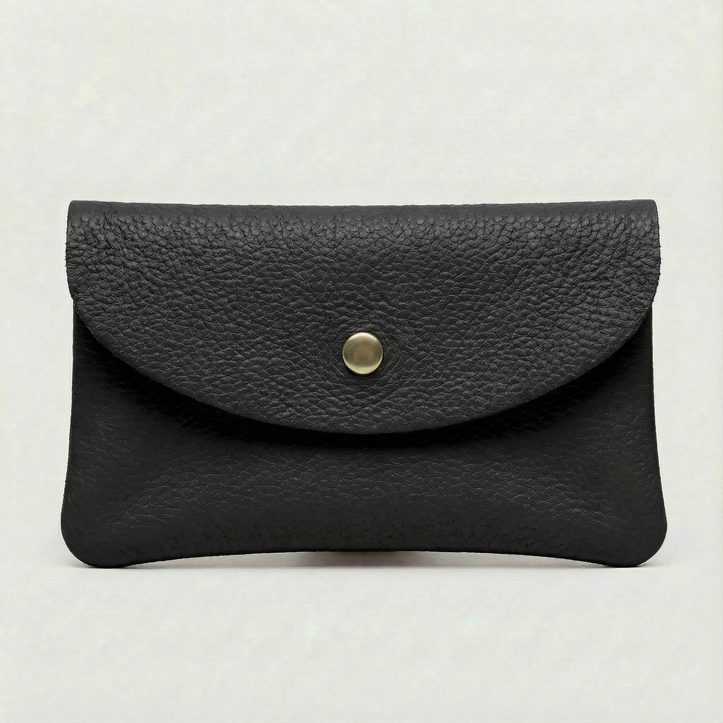 Black pebble leather coin wallet with snap closure, minimalist Italian design, compact and elegant everyday accessory.