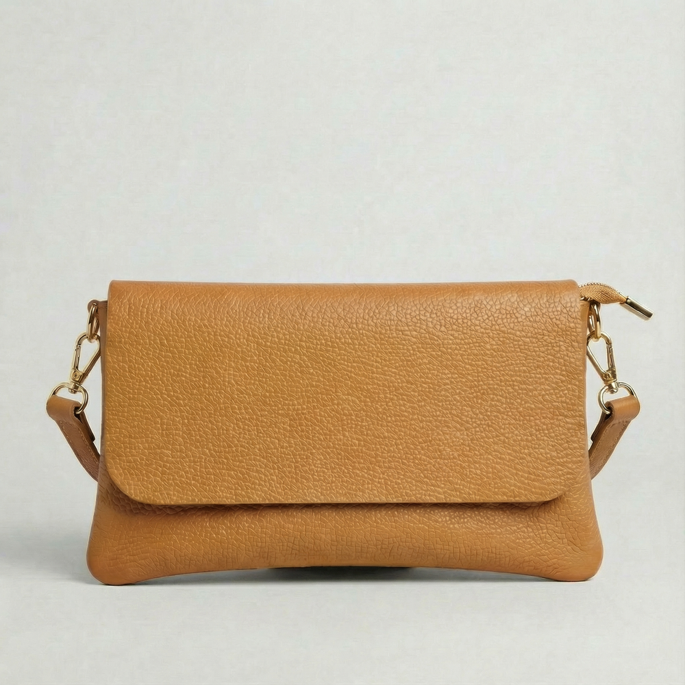 Camel pebble leather crossbody bag with a matching color adjustable strap, displayed on a light gray background.
