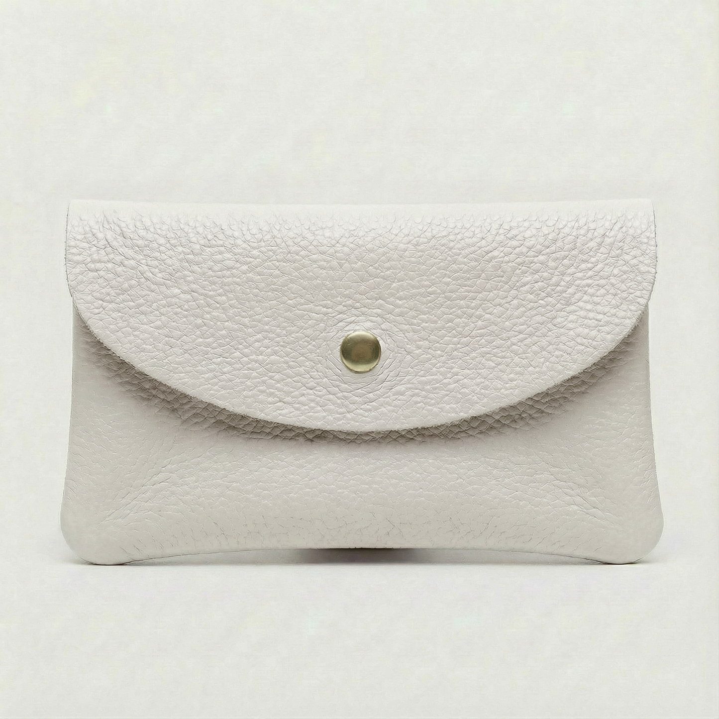White leather wallet with a gold button on a light gray background