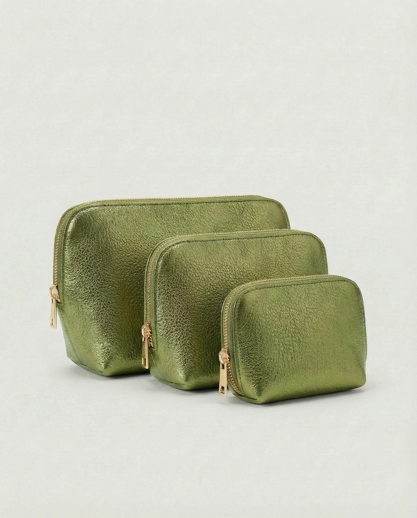 Metallic pistachio leather cosmetic bag with structured shape and top zip closure, shown in a sleek, minimalist style.