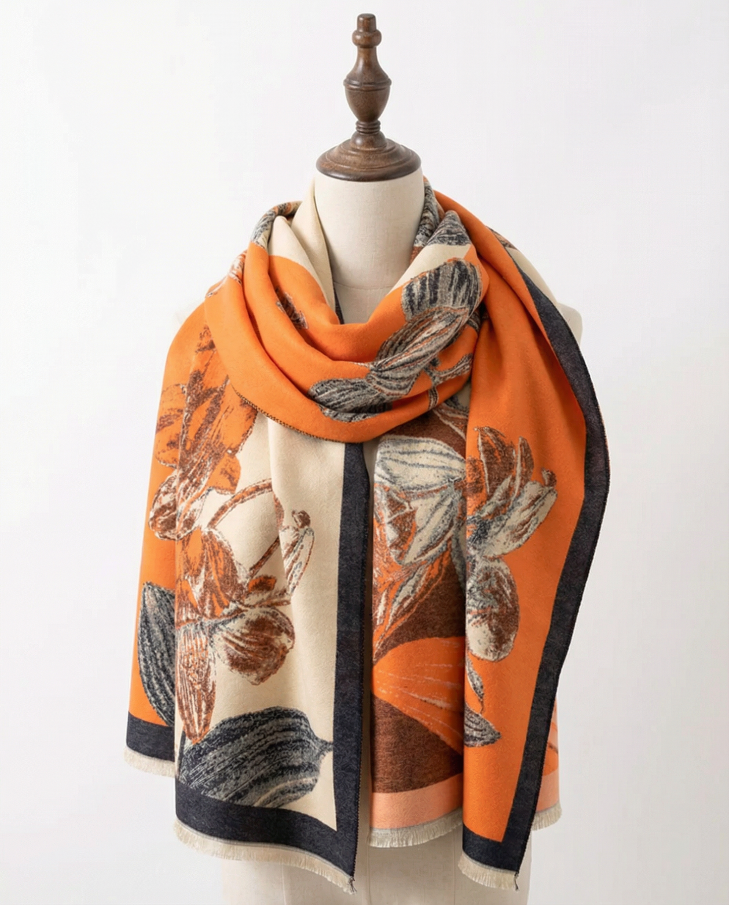 Orange wrap with floral pattern on a mannequin against a white background
