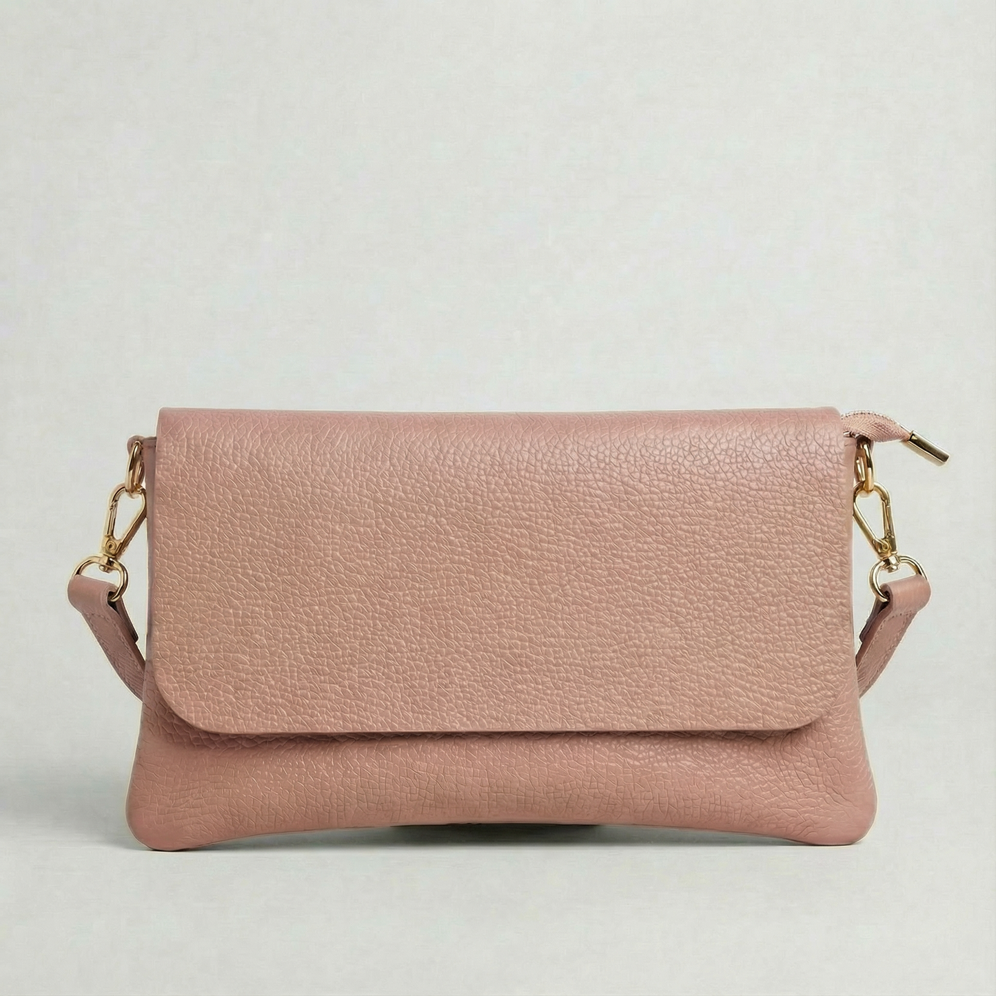 Dusty Rose pebble leather crossbody bag with a matching color adjustable strap, displayed on a light gray background.