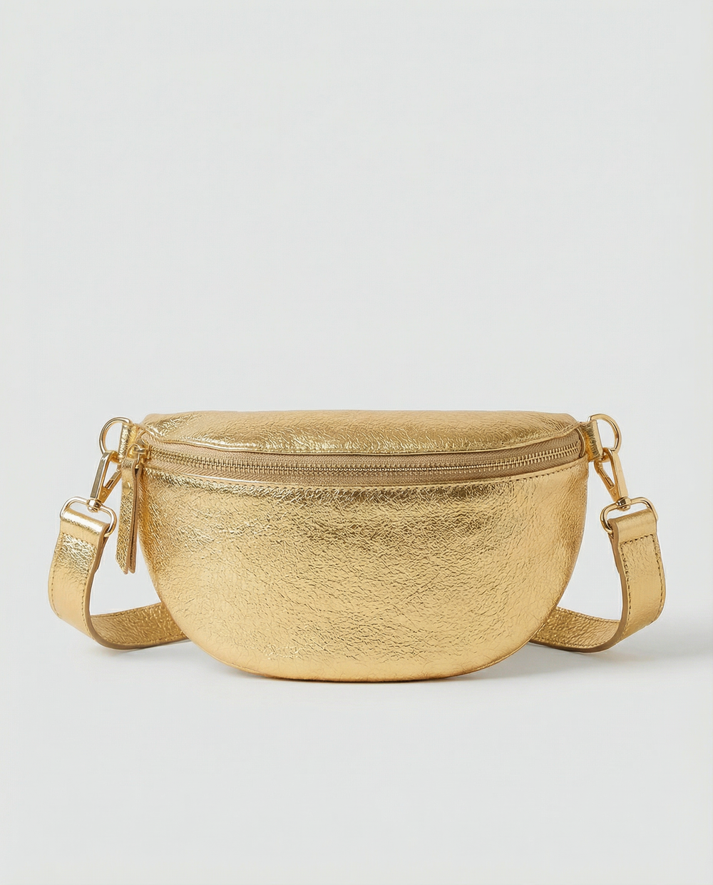 Metallic leather fanny bag in gold with adjustable strap and sleek, compact silhouette designed for hands‑free everyday wear.