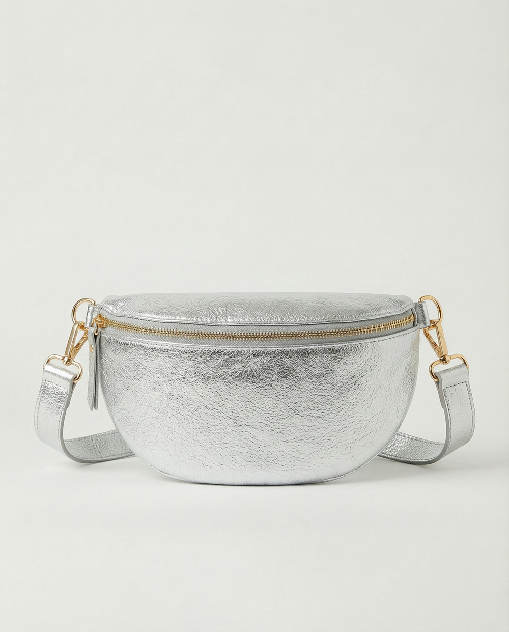 Metallic leather fanny bag in silver with adjustable strap and sleek, compact silhouette designed for hands‑free everyday wear.