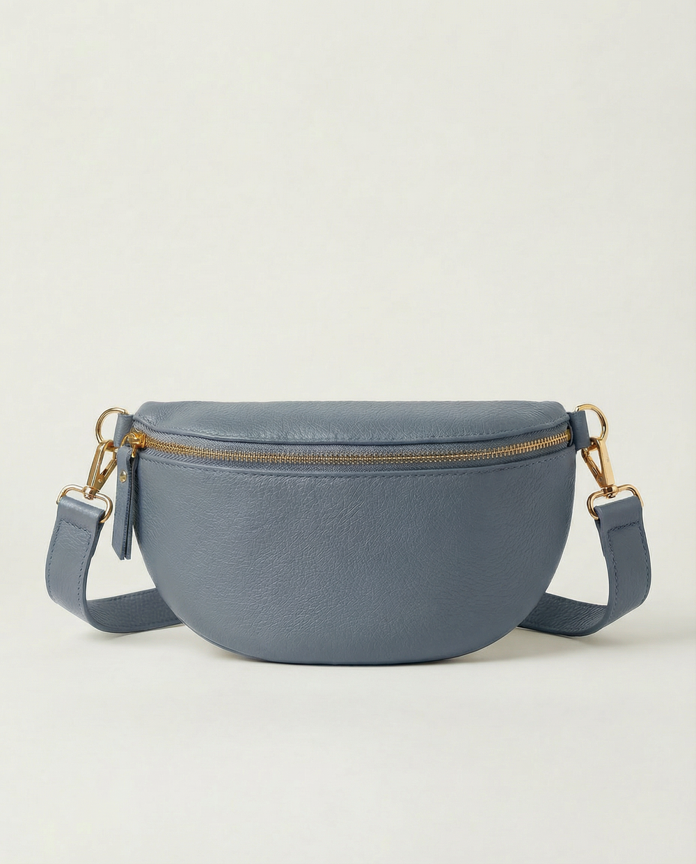 Denim pebble leather fanny bag with adjustable strap and compact, hands‑free design.
