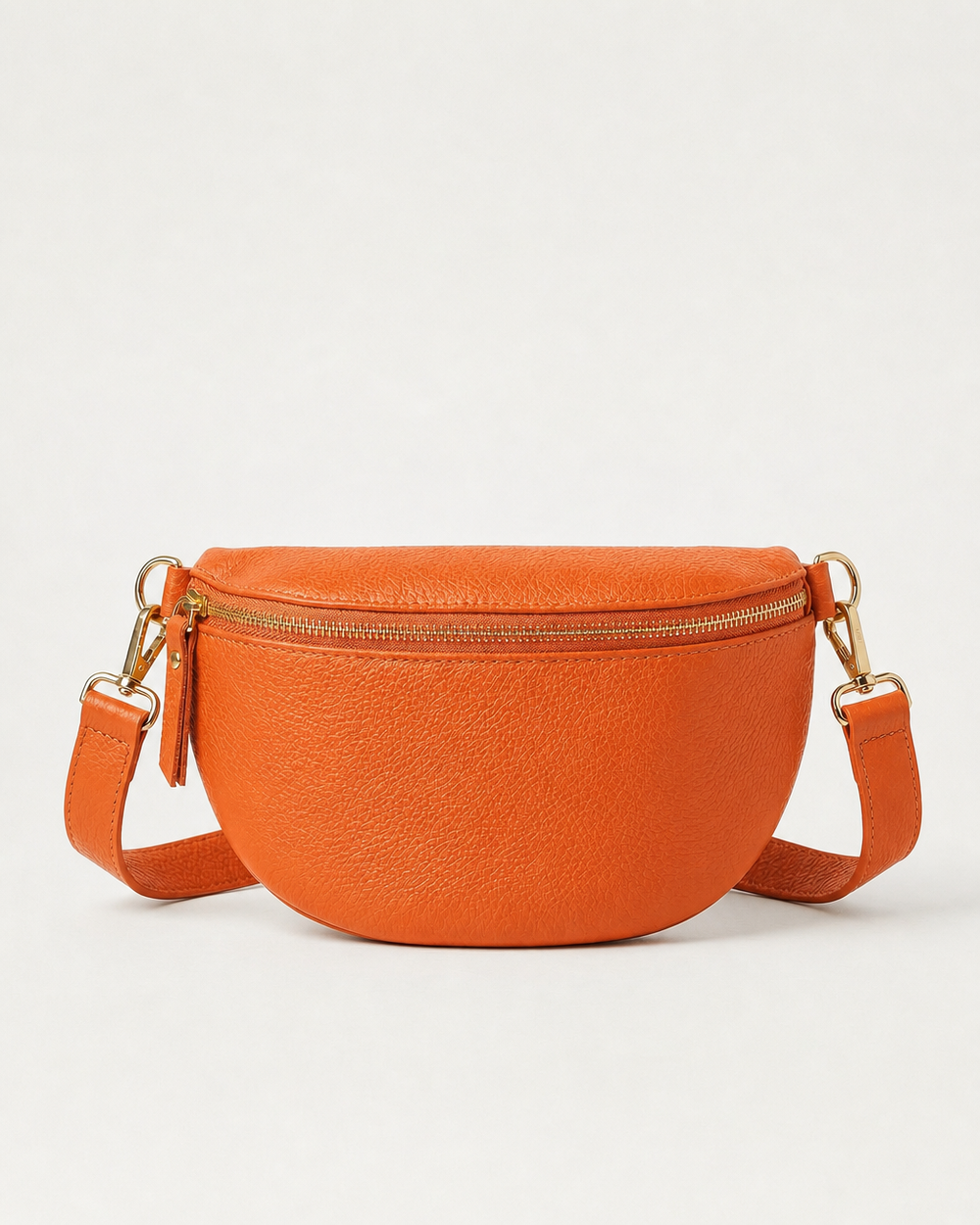 Orange pebble leather fanny bag with adjustable strap and compact, hands‑free design.