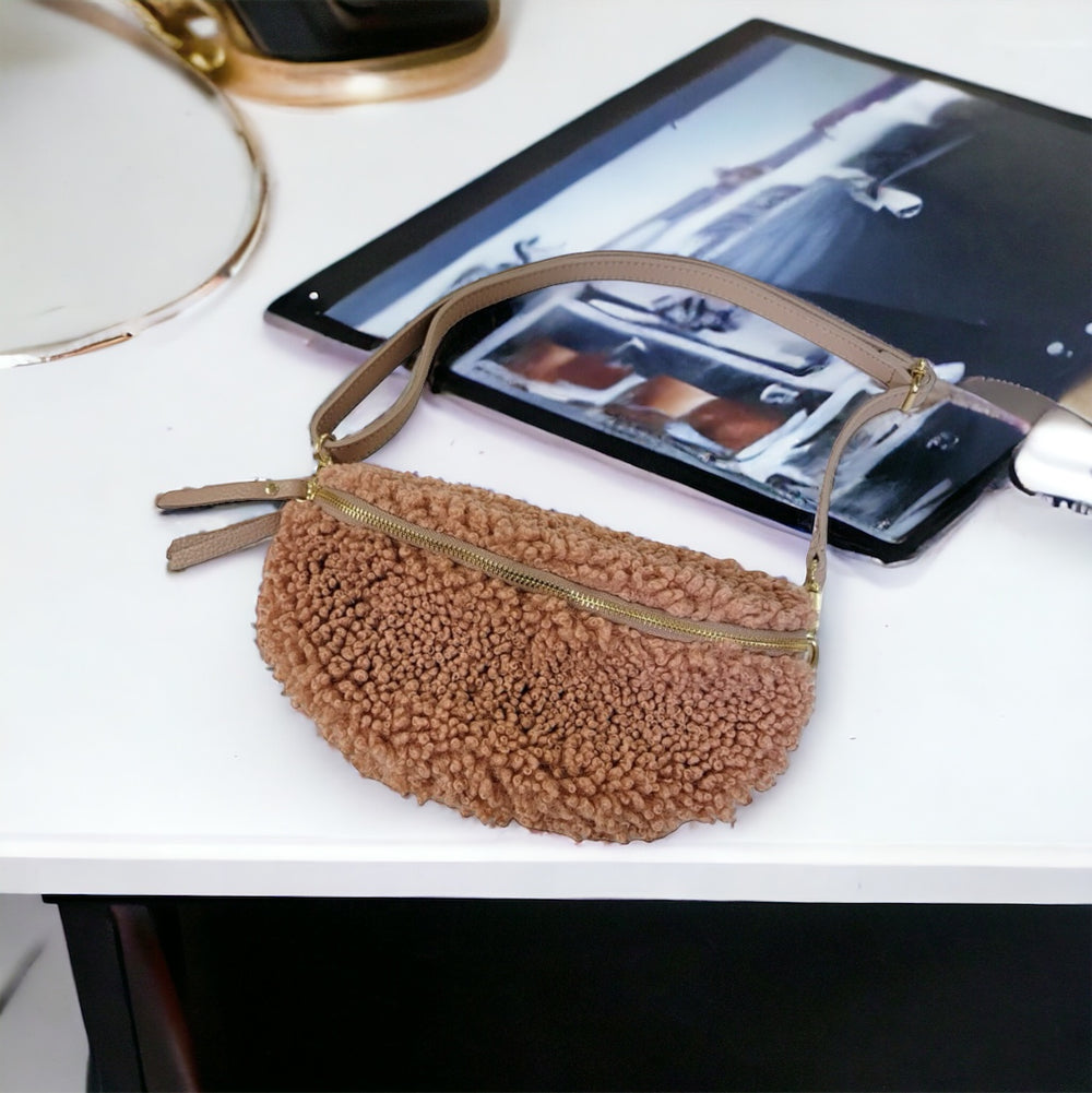 Caramel teddy fabric fanny bag with genuine leather accents, adjustable matching leather strap, and zip closure, made in Italy.