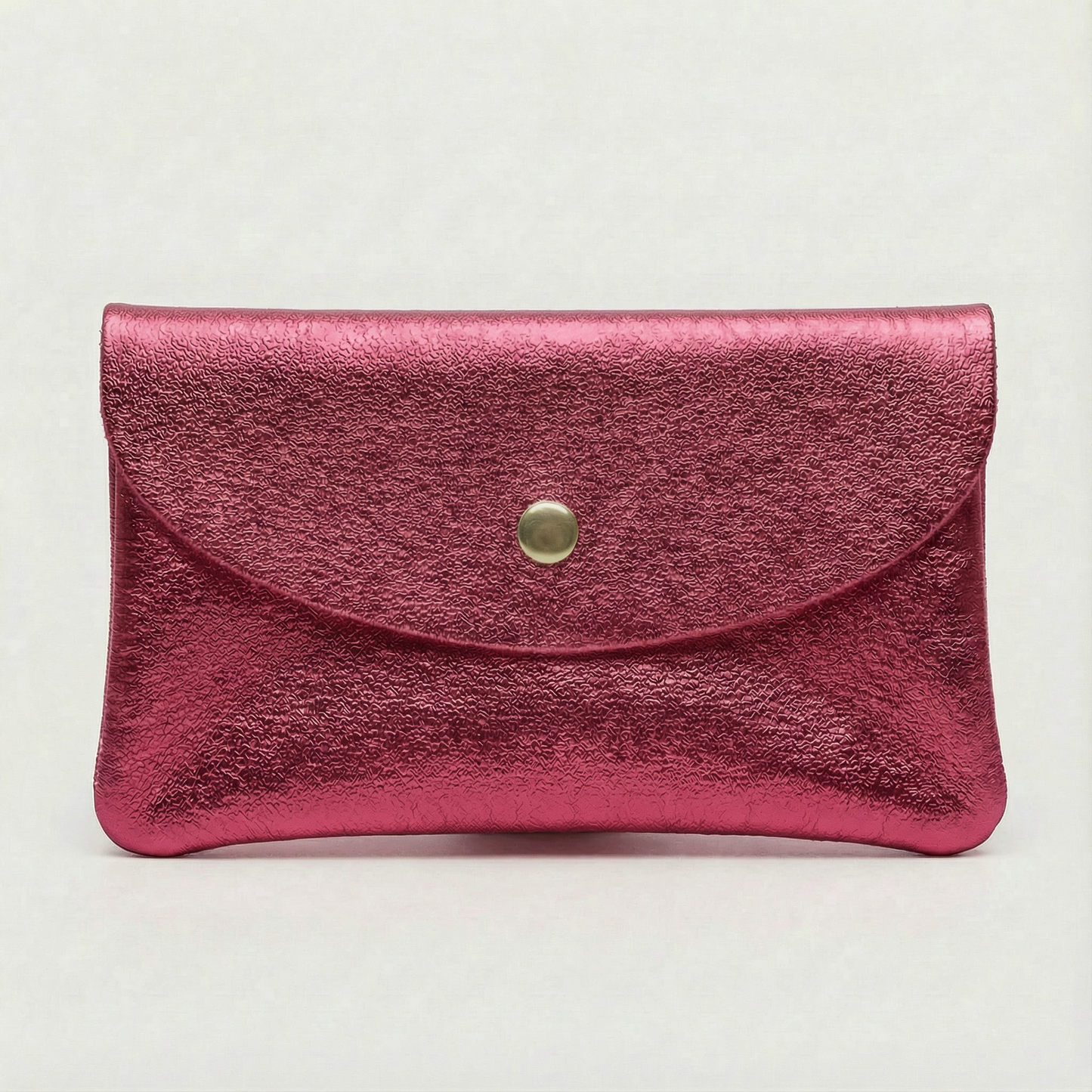 Flamingo metallic leather cellphone wallet with a gold button on a light gray background