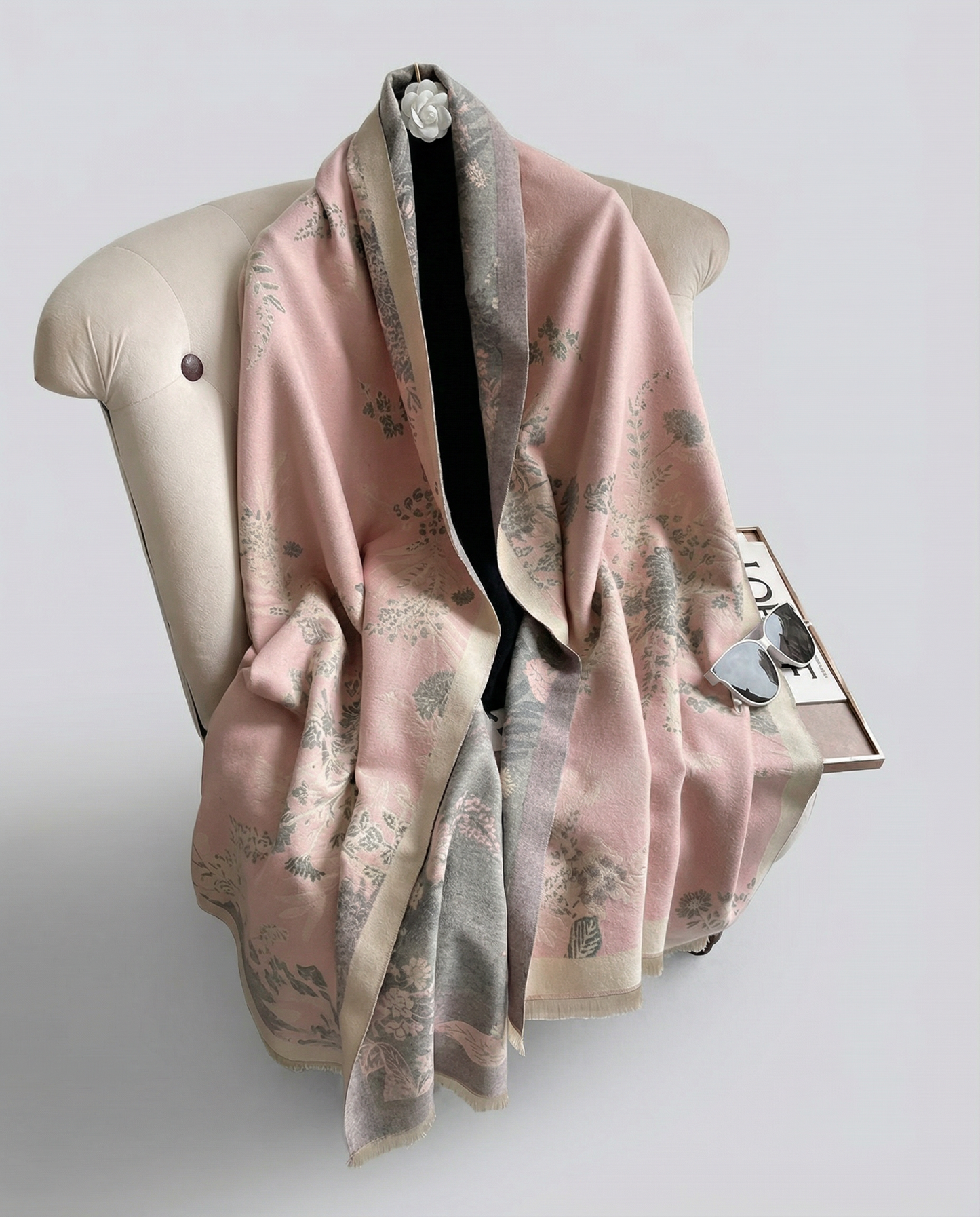 Pink floral scarf draped over a mannequin on a light gray background