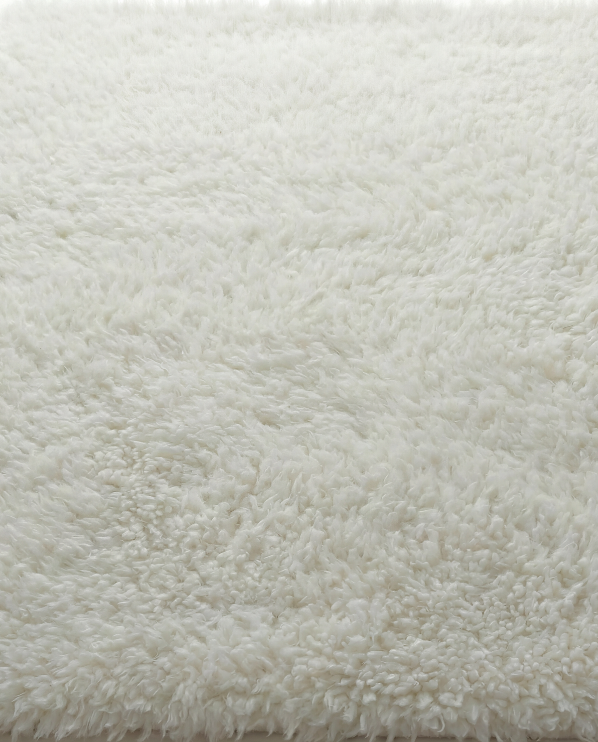 Lamb’s Wool Throw in Ivory with a soft, natural wool texture.
