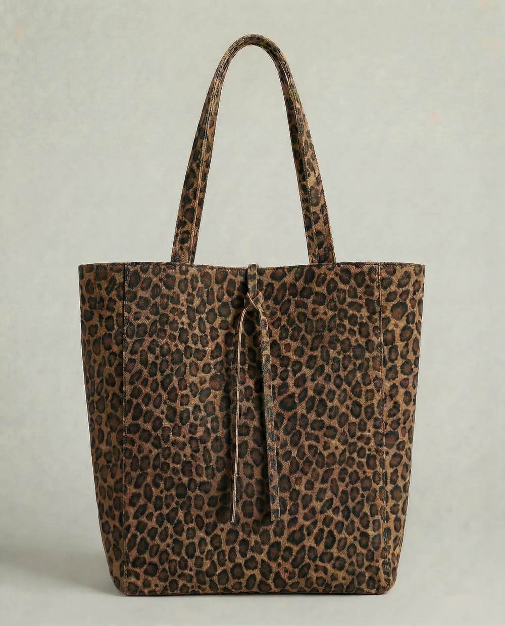Leopard pebble leather tote bag with structured shape and elegant, minimalist design.