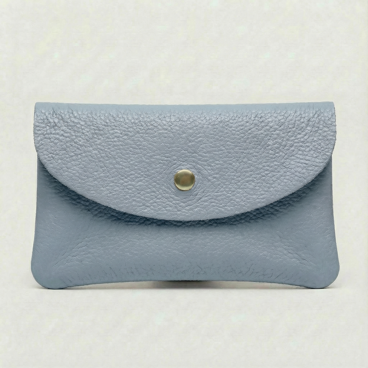 Light Blue pebble leather wallet collection featuring Mini Coin Wallet, Coin Wallet, and Cellphone Wallet in genuine leather, made in Italy.