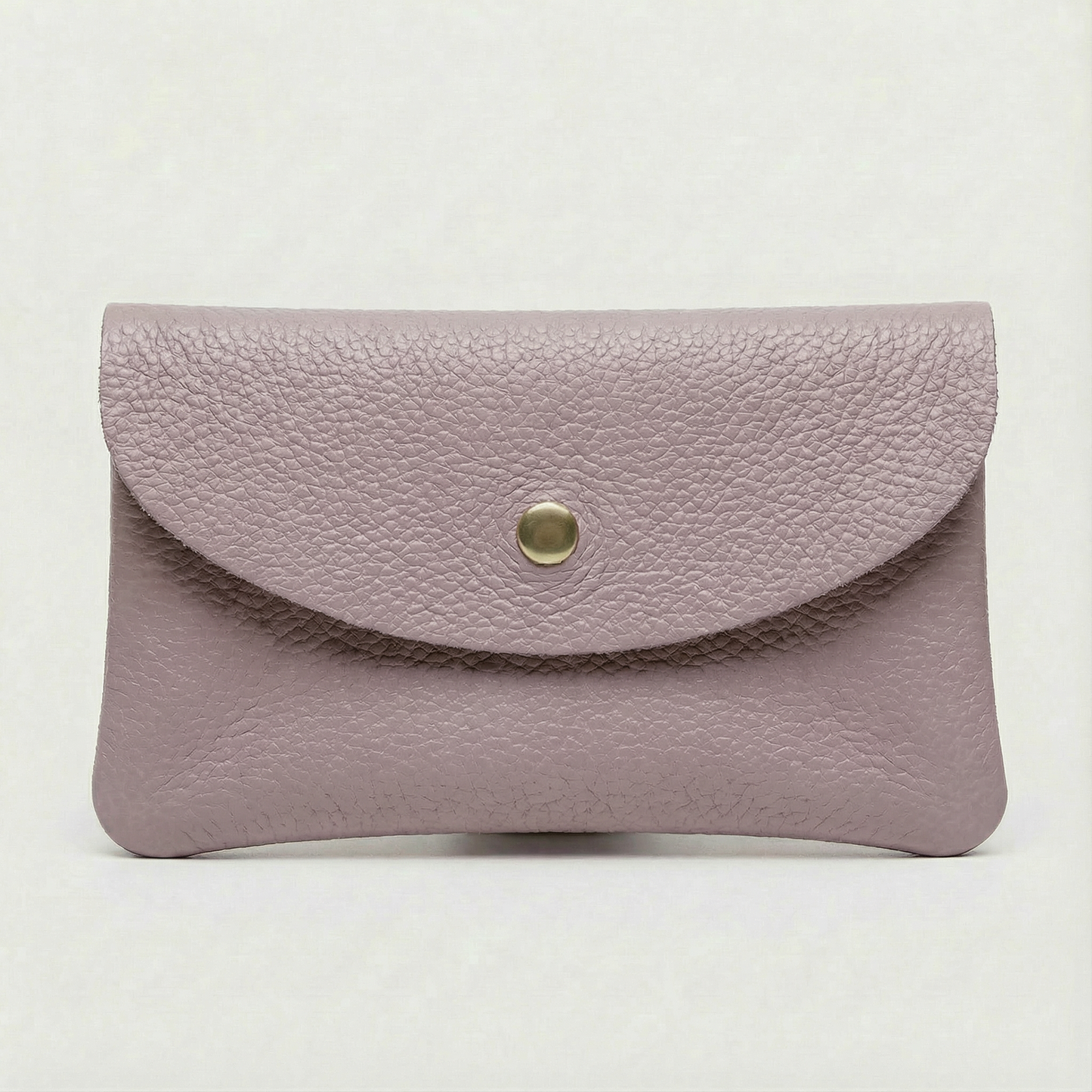 Lilac pebble leather coin wallet with snap closure, minimalist Italian design, compact and elegant everyday accessory.