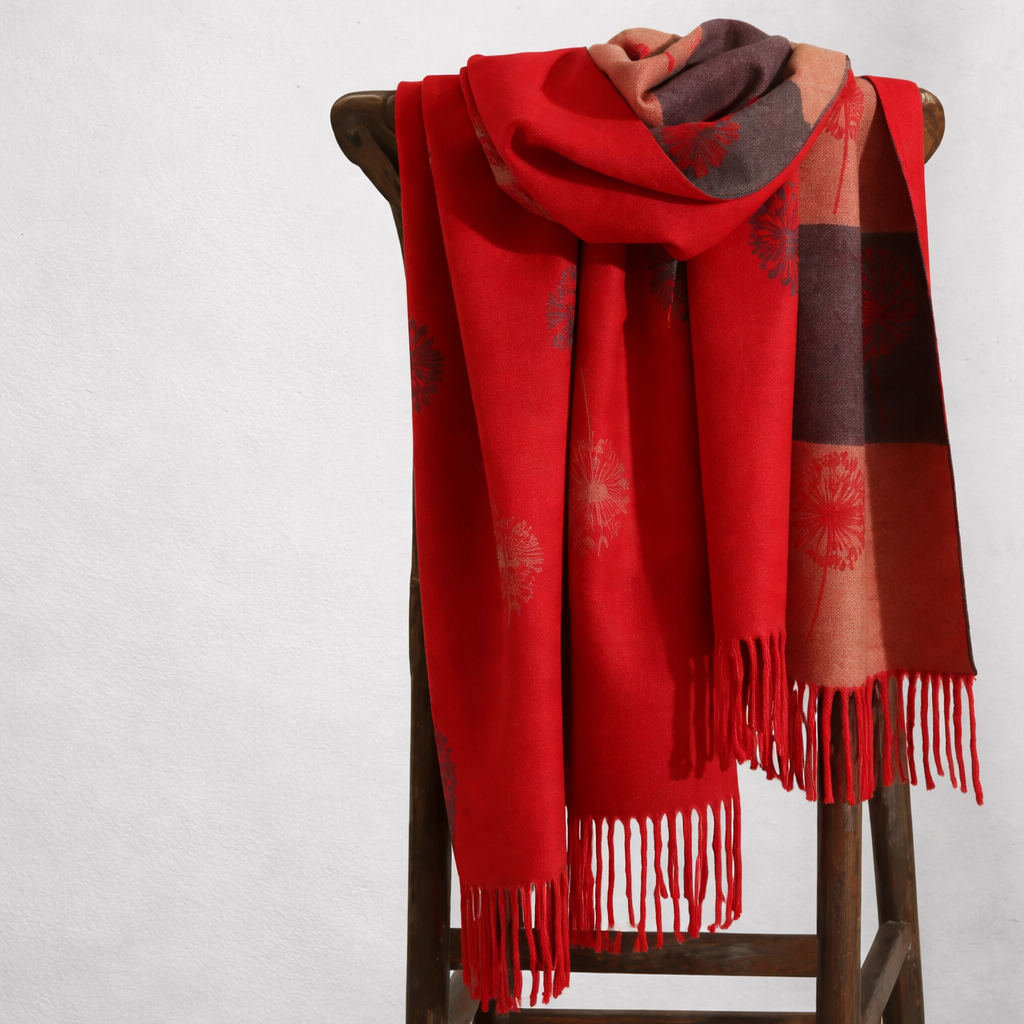 Red wrap with plaid pattern draped over a wooden stand on a white background