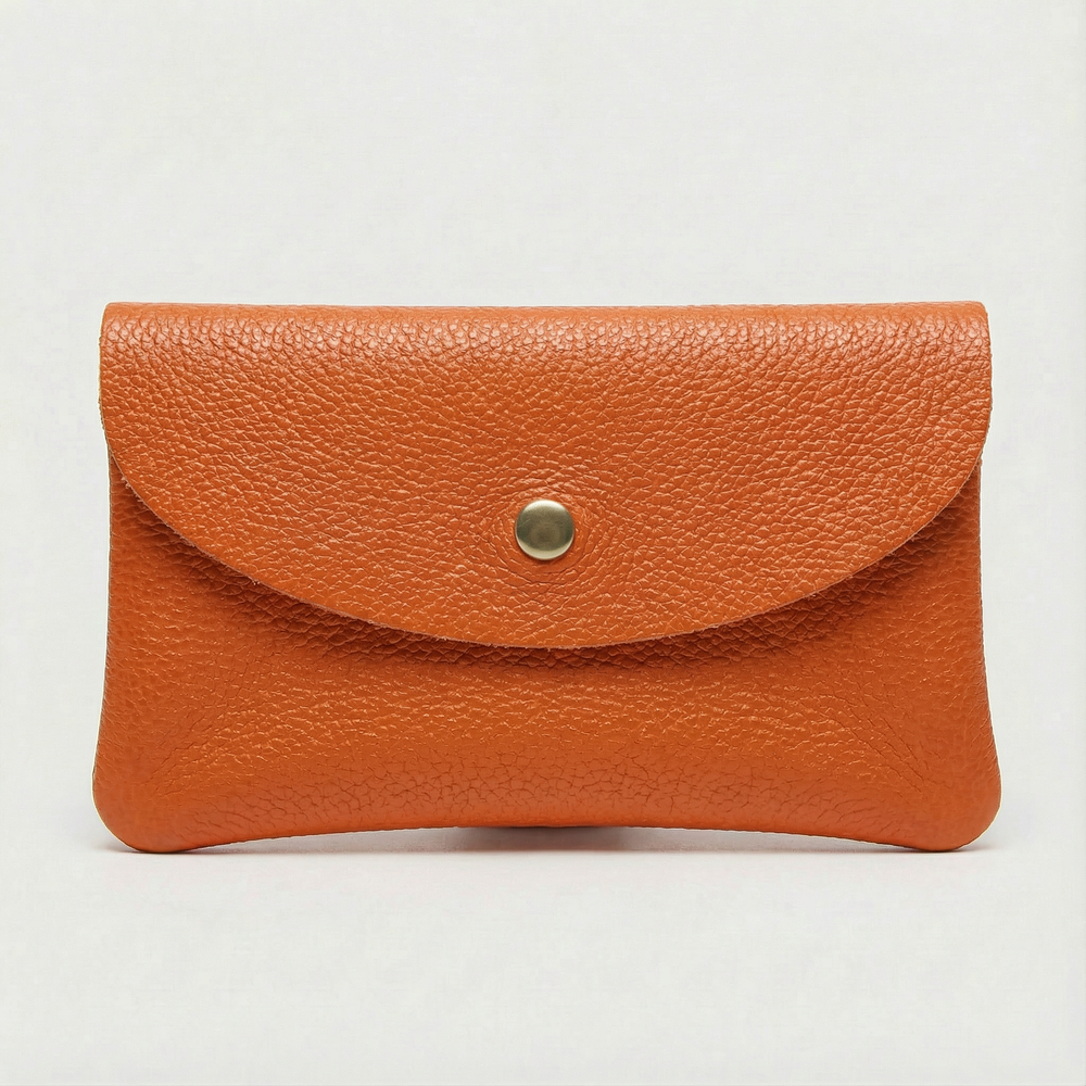Orange pebble leather wallet collection featuring Mini Coin Wallet, Coin Wallet, and Cellphone Wallet in genuine leather, made in Italy.