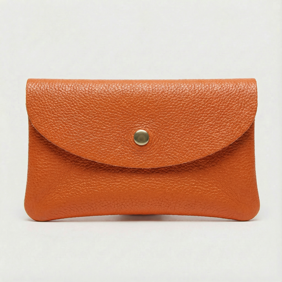 Orange pebble leather wallet collection featuring Mini Coin Wallet, Coin Wallet, and Cellphone Wallet in genuine leather, made in Italy.