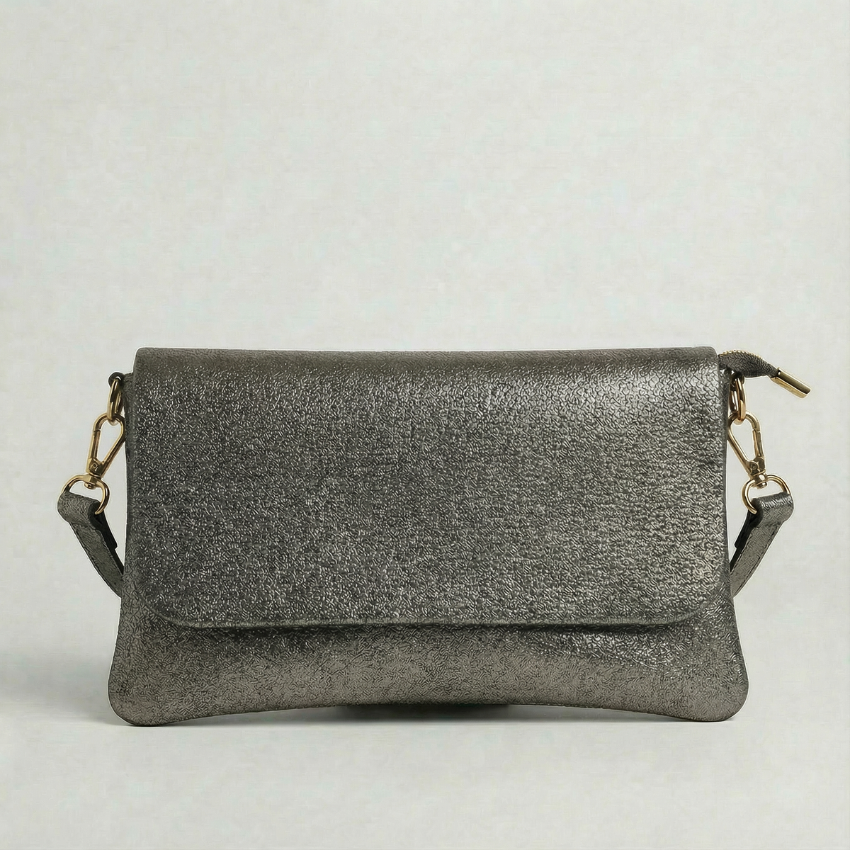 Pewter metallic leather crossbody bag with a matching color leather strap, displayed on a light gray background.