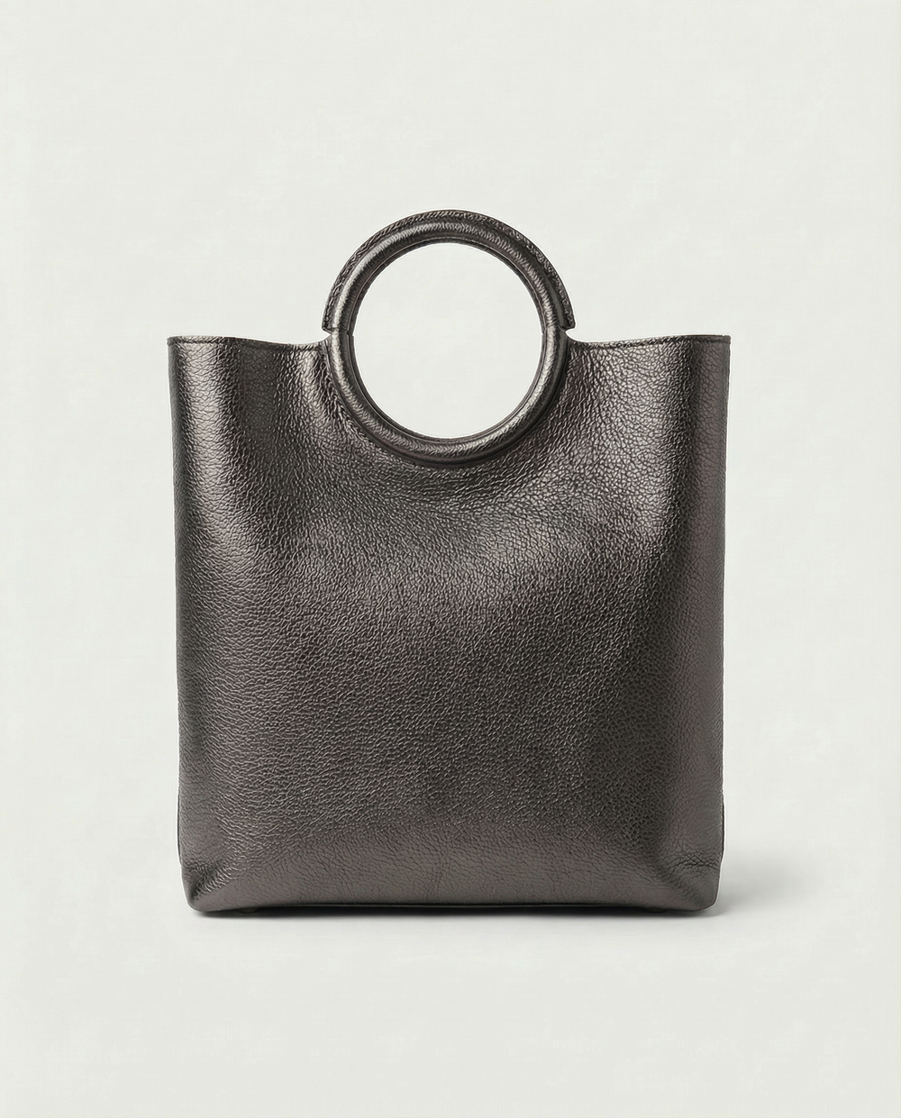 Metallic pewter leather ring bag with circular top handle and structured silhouette, sleek and modern design.
