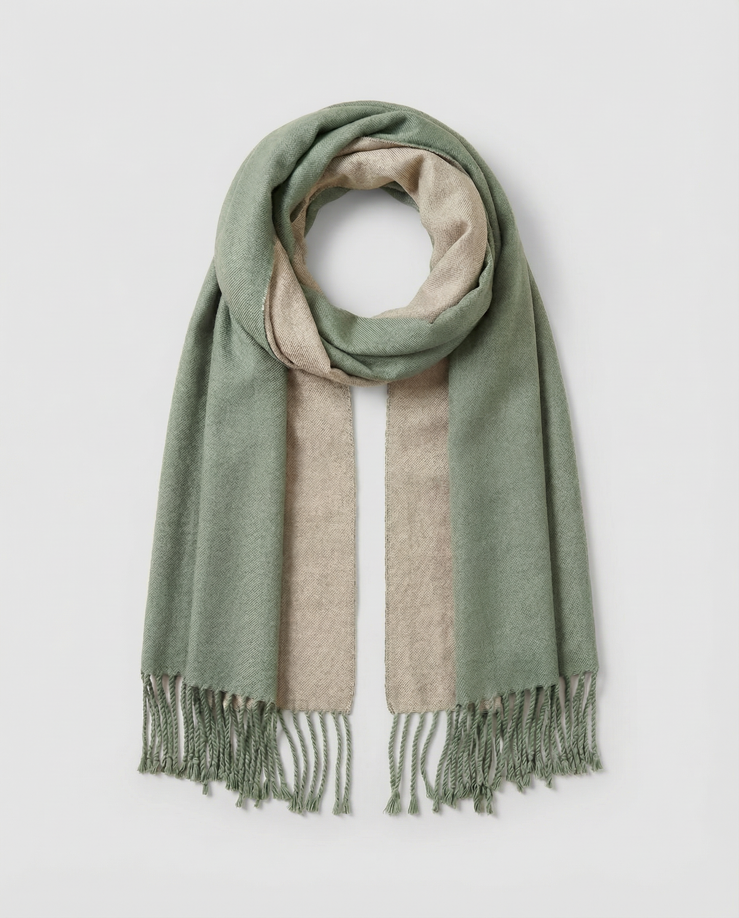 Green and beige striped wrap with fringes on a light gray background
