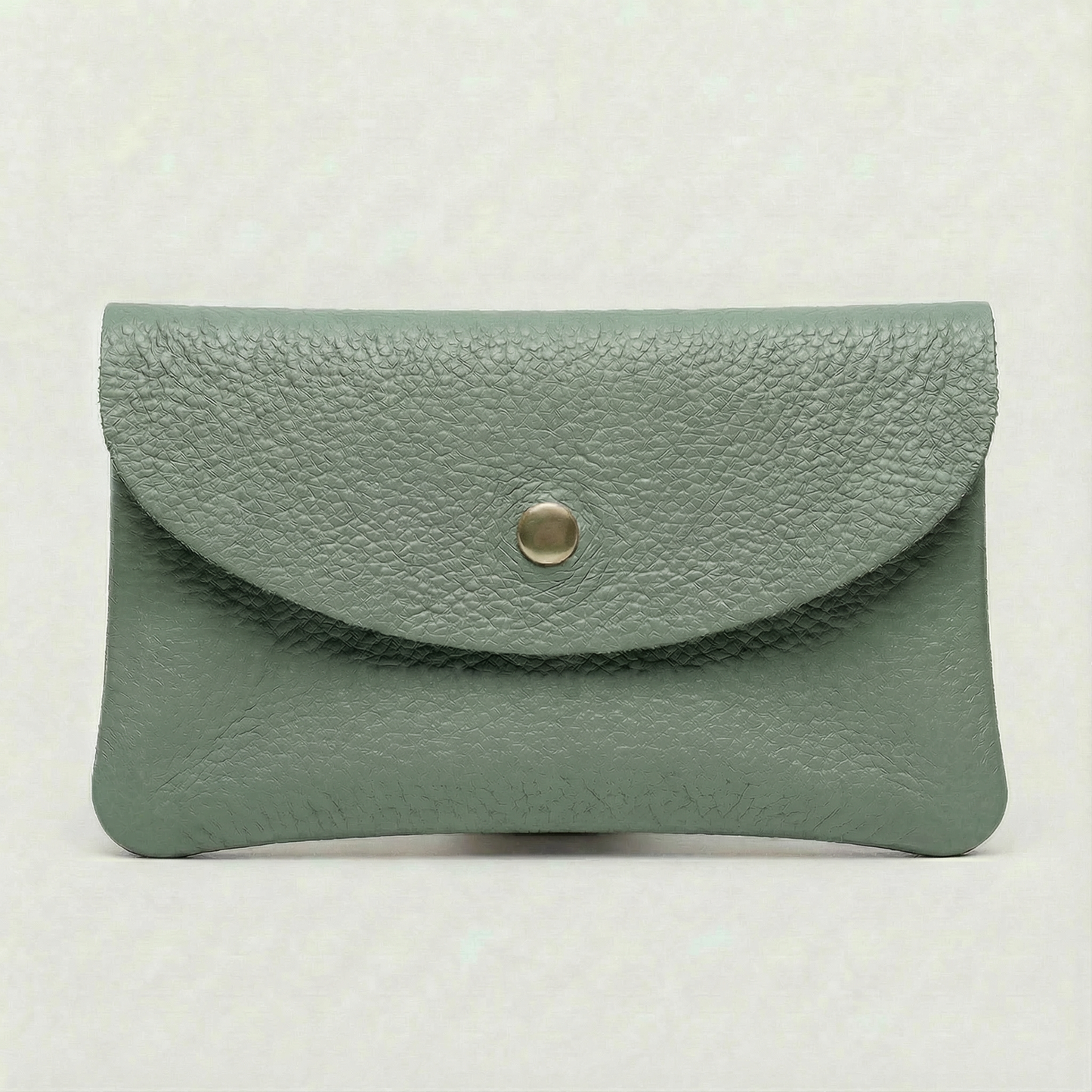 Spruce pebble leather coin wallet with snap closure, minimalist Italian design, compact and elegant everyday accessory.