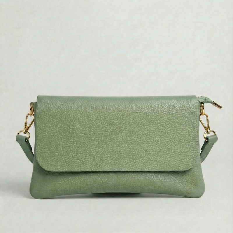 Spruce pebble leather crossbody bag with a matching color adjustable strap, displayed on a light gray background.