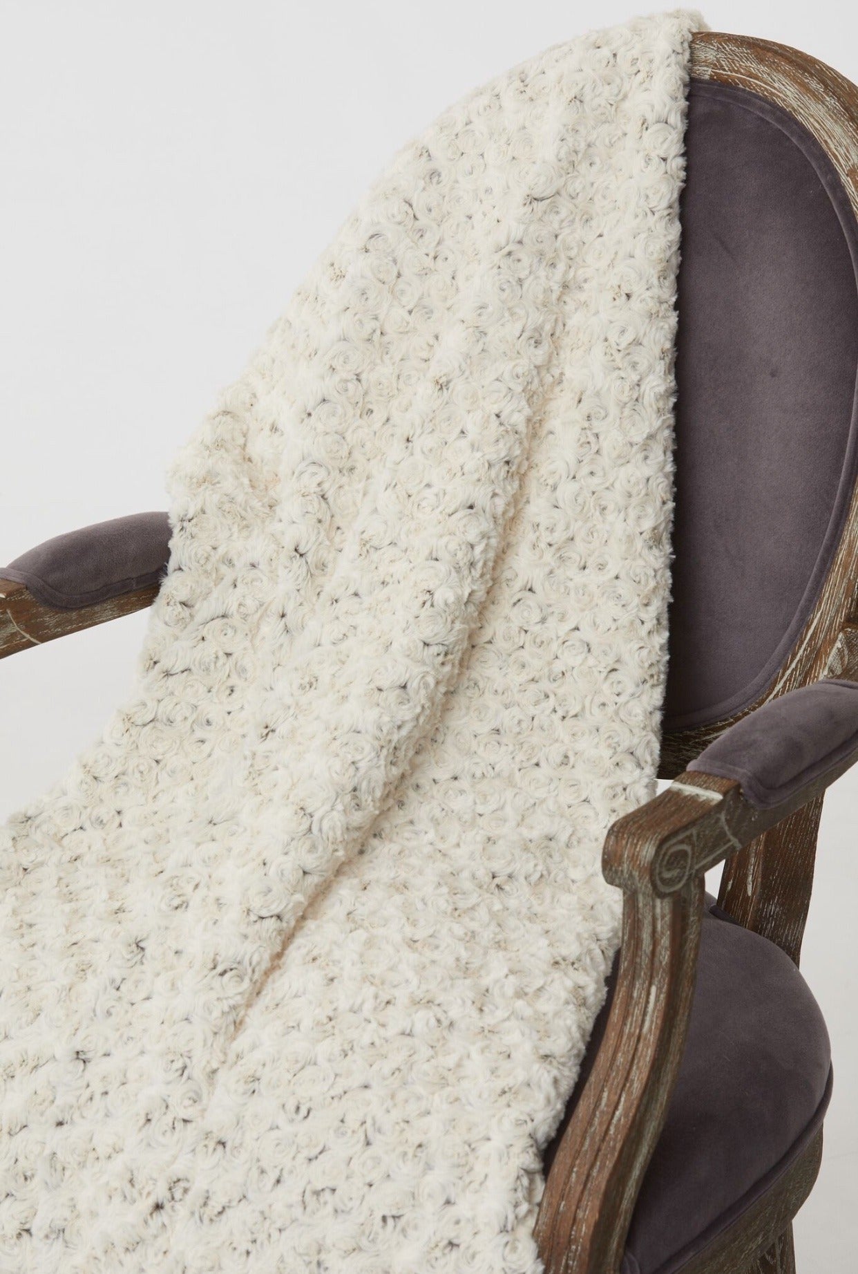 Rosebud Duotone Throw in Cream & Chocolate On display chair