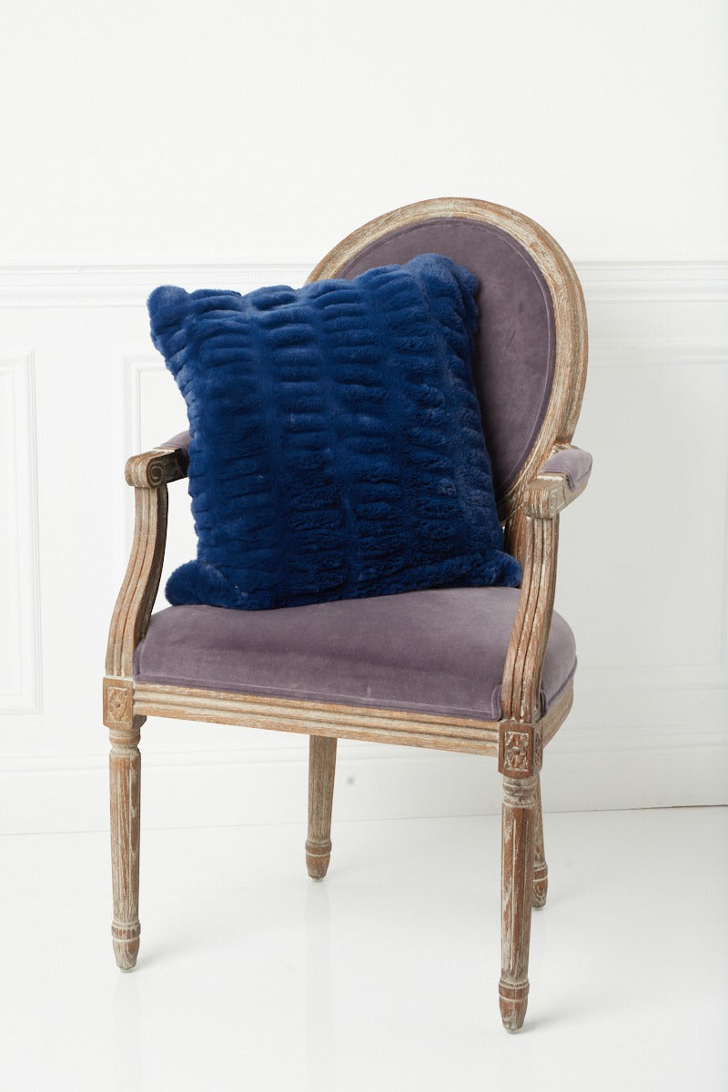 Lower angle of Florence Navy Pillow on chair
