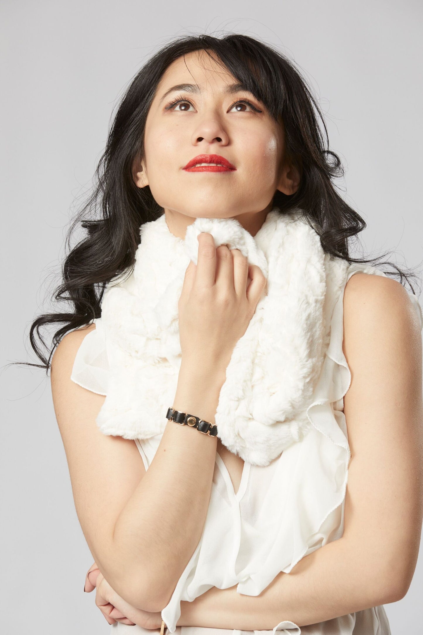 Woman looking up wearing Lux Cuddle Scarf in Ivory