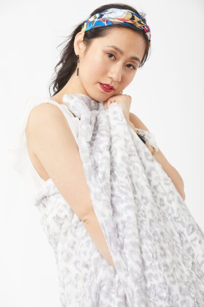 Woman posing wearing Wild Jacquard Luscious Throw – Silver