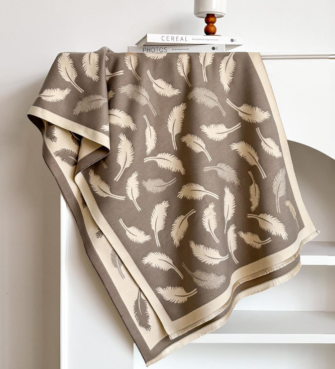 Folded fabric with feather pattern on a white surface