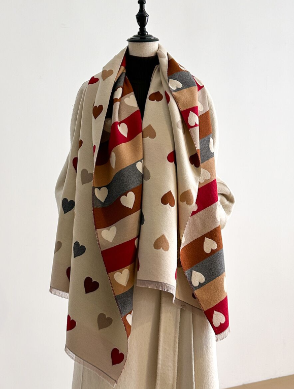 Mannequin wearing a colorful heart-patterned wrap on a white background