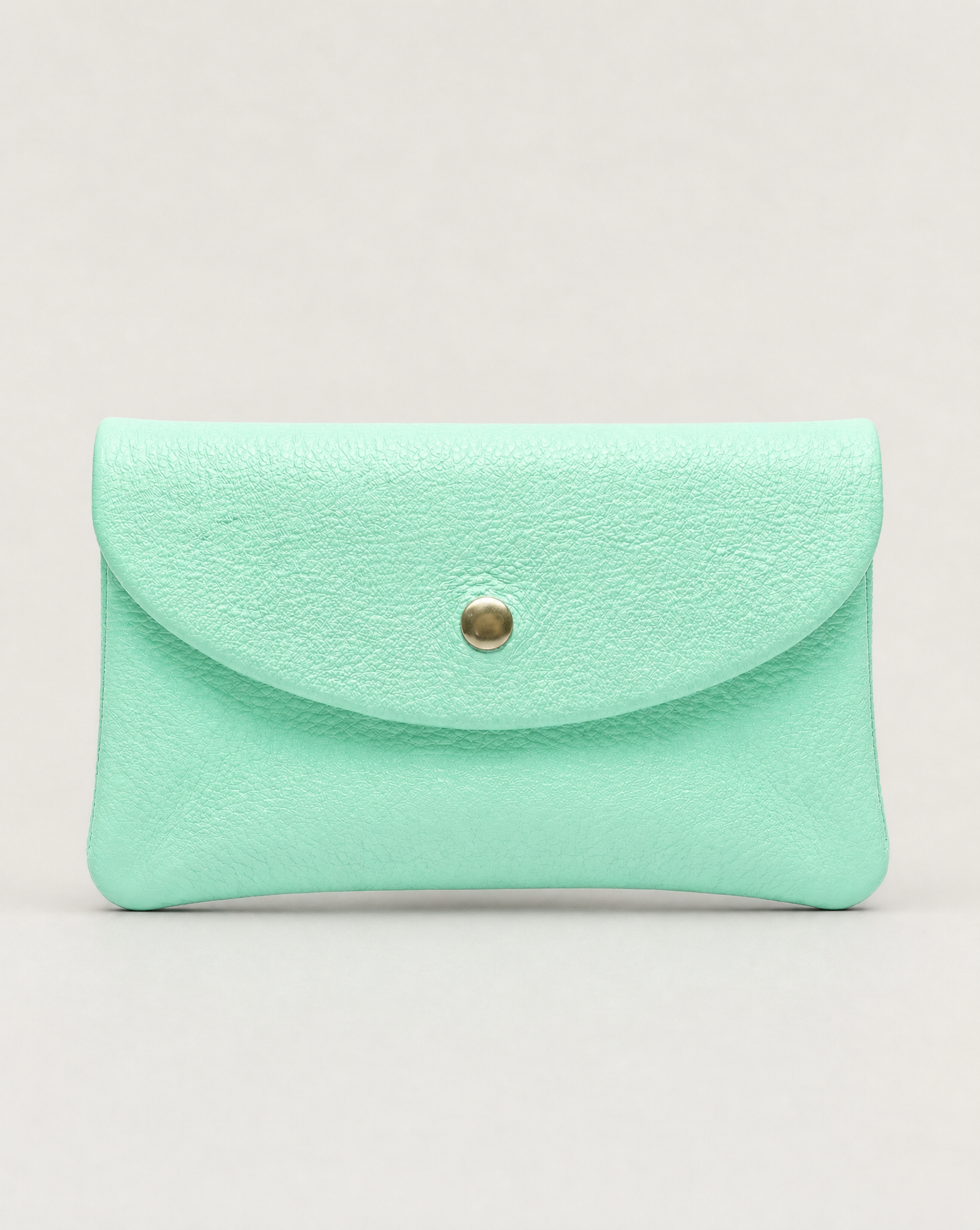 Aqua pebble leather coin wallet with snap closure, minimalist Italian design, compact and elegant everyday accessory.