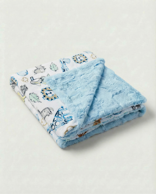Folded blue baby blanket with animal pattern on a light gray background