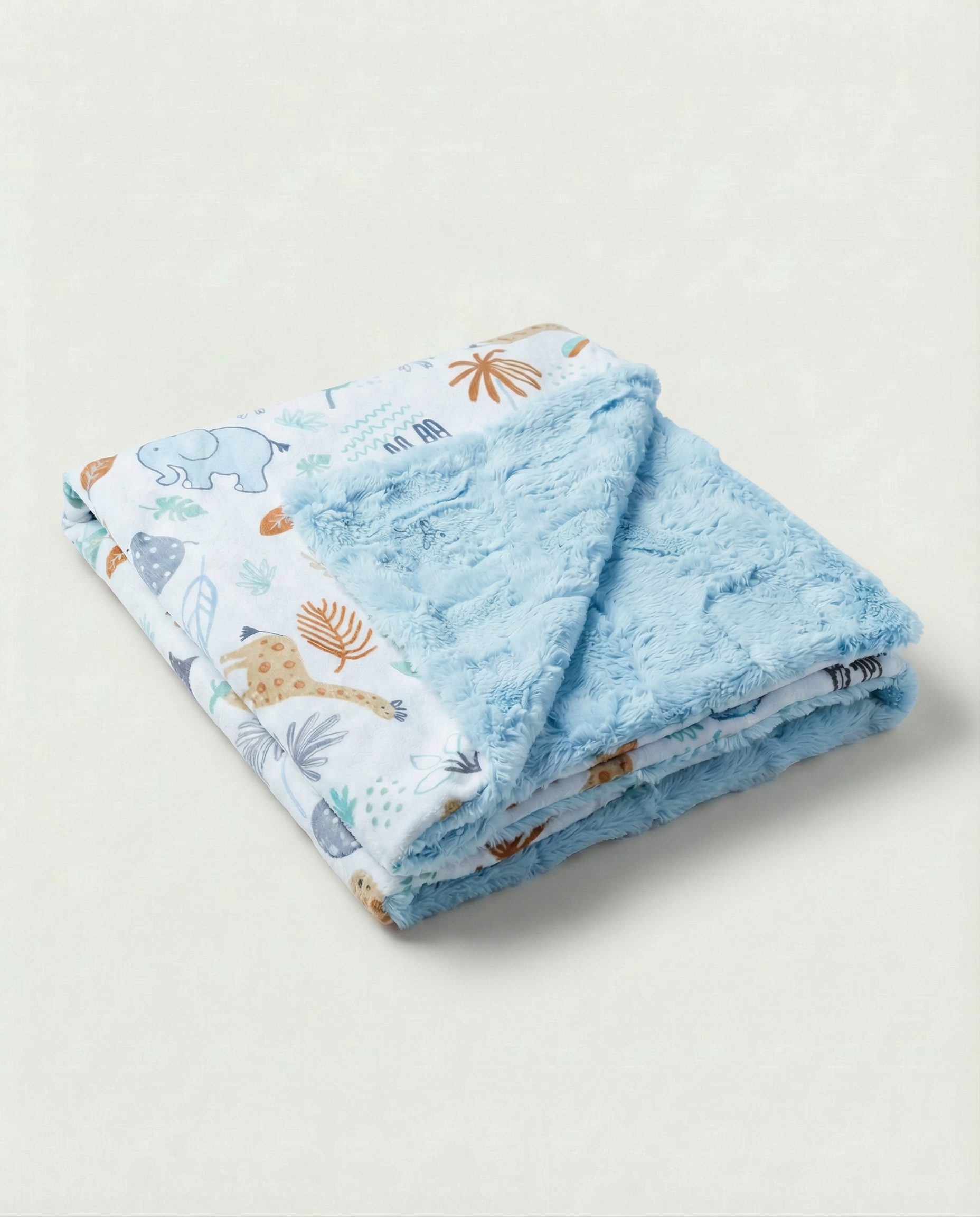 Folded blue baby blanket with animal prints on a light gray background