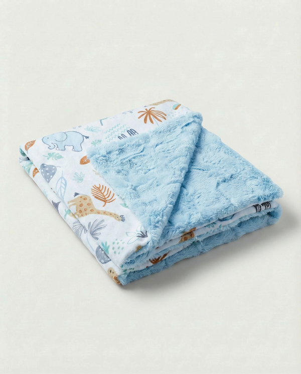 Folded blue baby blanket with animal prints on a light gray background