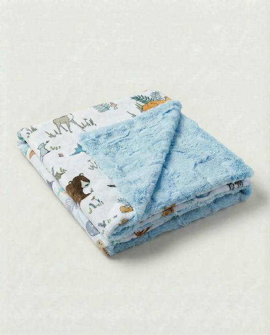 Folded baby blanket with animal pattern on a light gray background