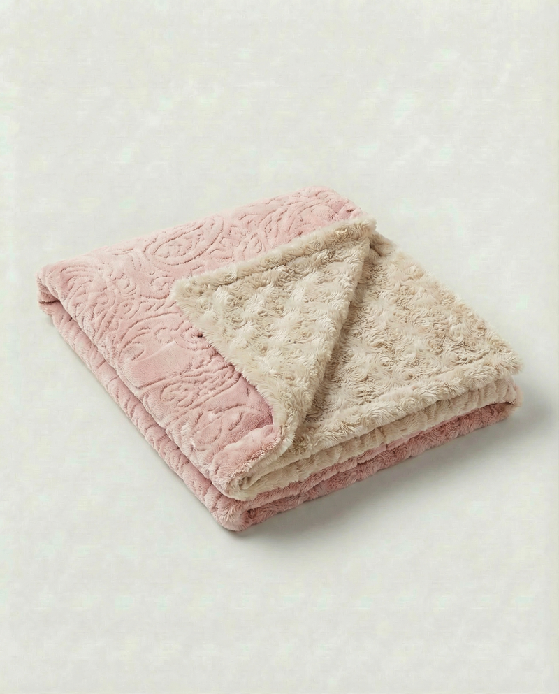 Soft baby blanket with paisley pattern and plush pink embossed rosebud backing, perfect for cozy newborn snuggles.