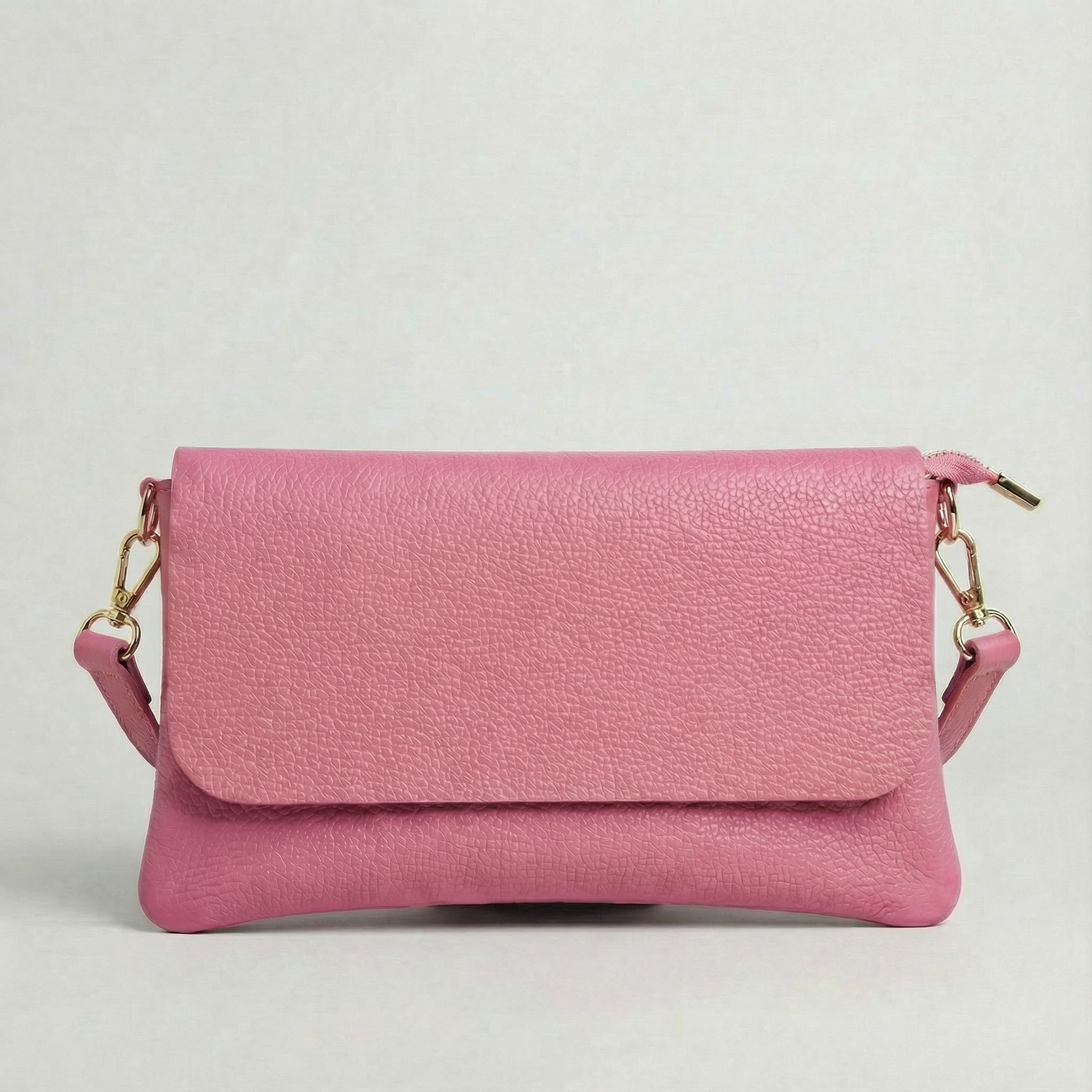 Barbie Pink pebble leather crossbody bag with a matching color adjustable strap, displayed on a light gray background.