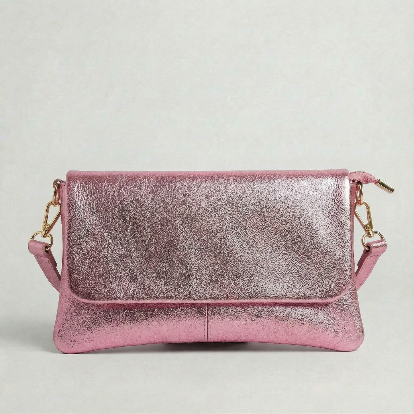Barbie Pink metallic leather crossbody bag with a matching color leather strap, displayed on a light gray background.