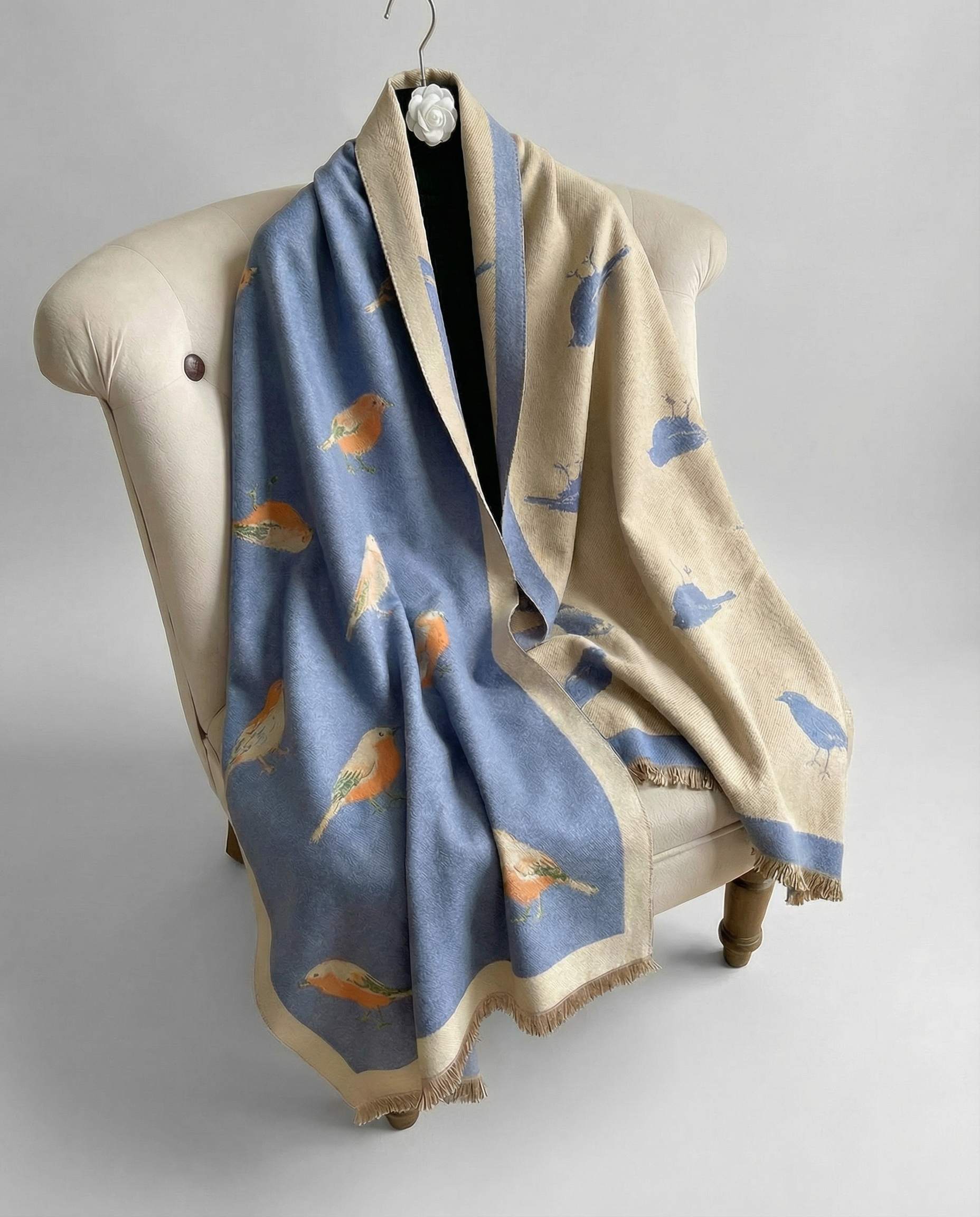 Blue wrap with bird pattern on a chair with light gray background