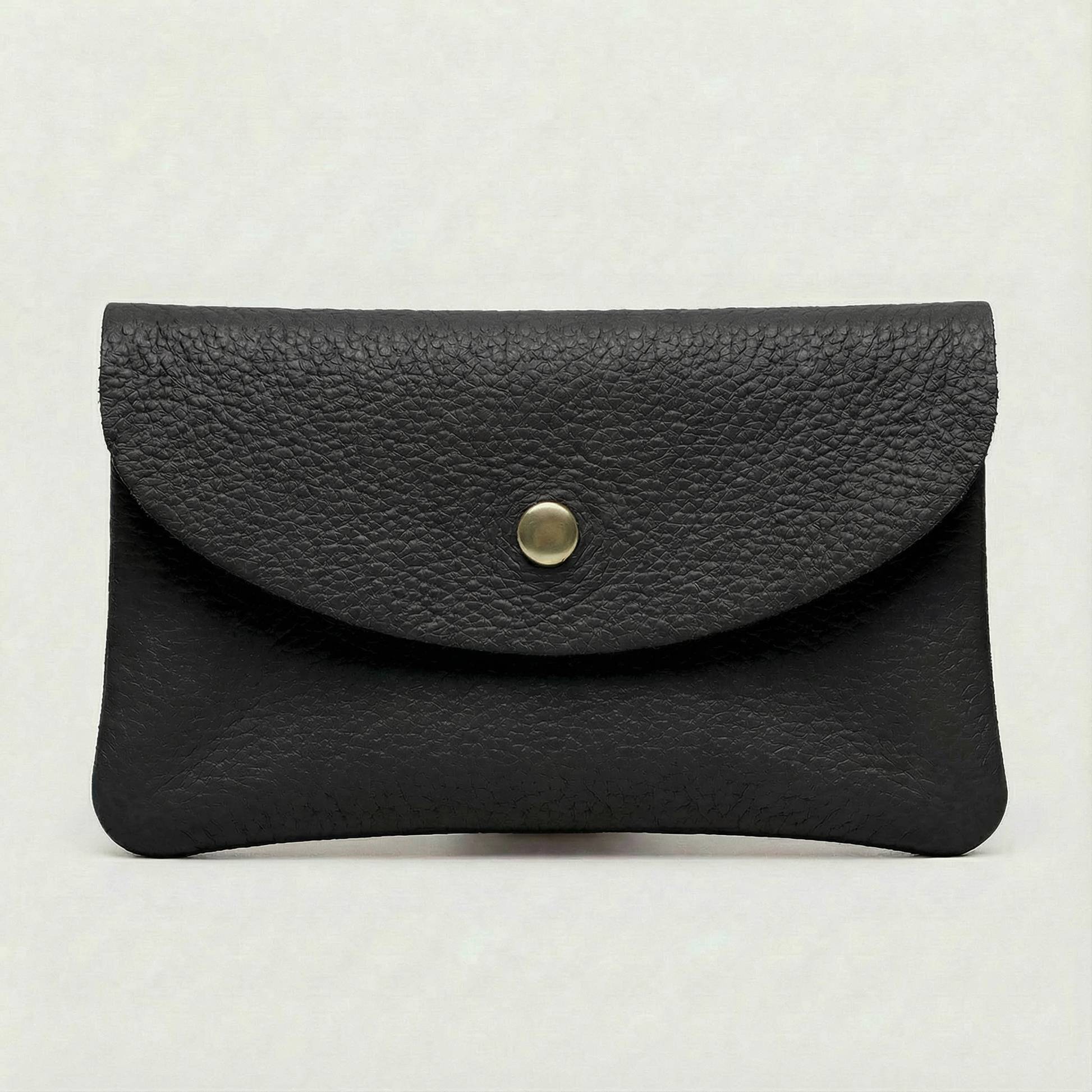 Black pebble leather coin wallet with snap closure, minimalist Italian design, compact and elegant everyday accessory.